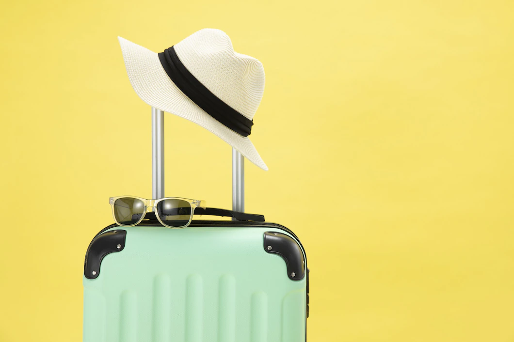 top-view-suitcase-sunglasses-camera-hat-yellow-background-vacation-concept-181624-31433.webp