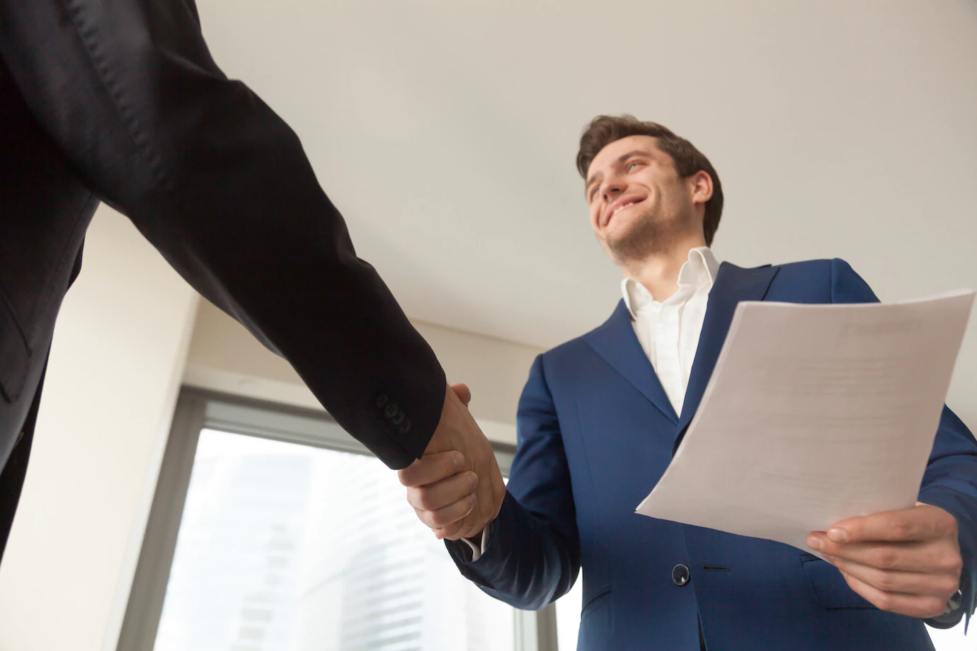 smiling-company-manager-welcoming-client-office-1163-5290.webp