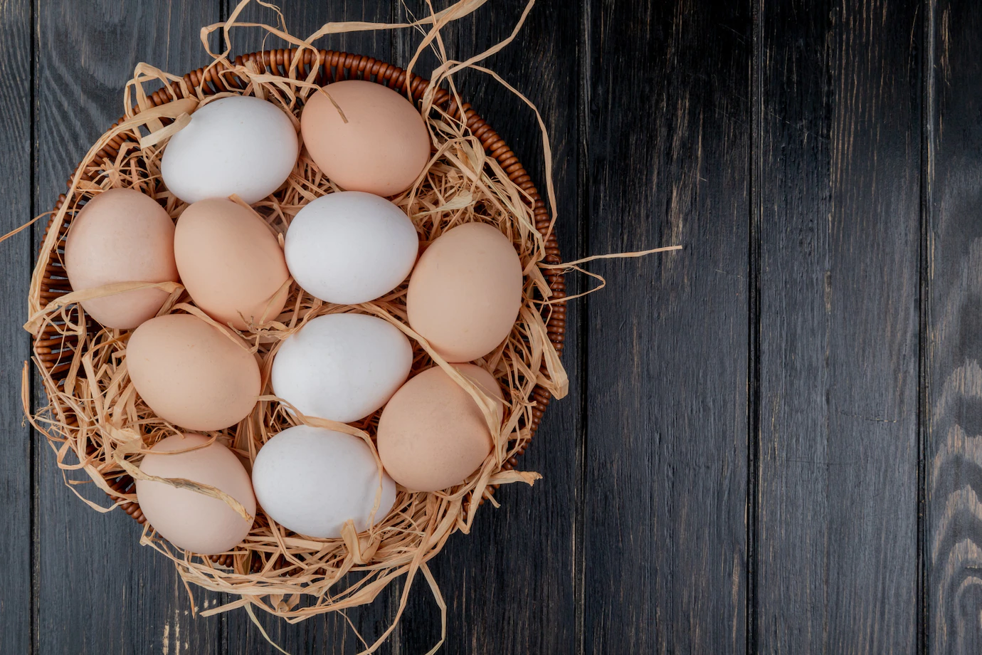 top-view-fresh-chicken-eggs-nest-wooden-background-with-copy-space-141793-14800.webp