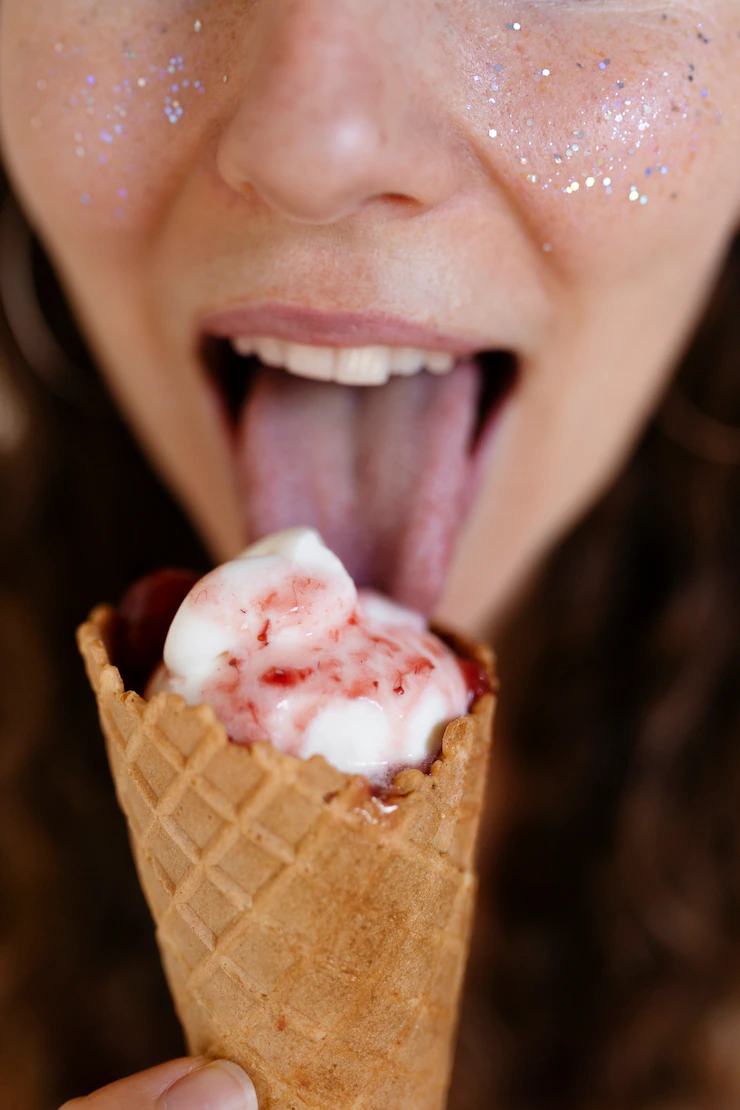 high-angle-woman-licking-ice-cream-cone-23-2149426771.webp