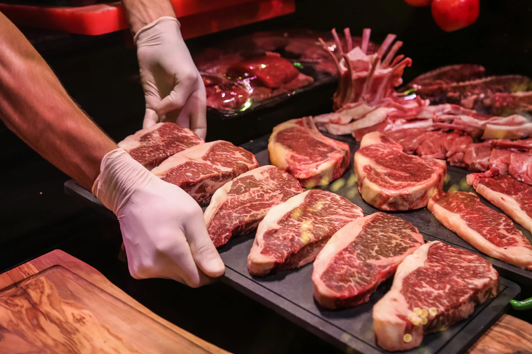 side-view-chef-makes-raw-marbled-beef-steaks-stand-141793-12509.webp