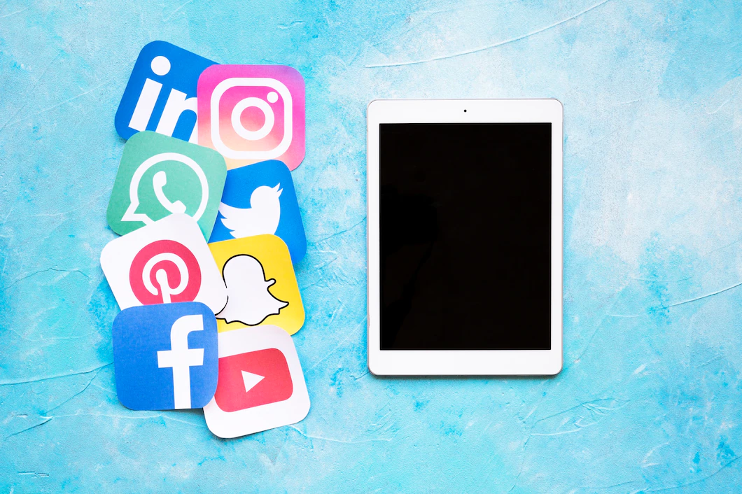 digital-tablet-placed-near-rounded-icons-social-media-printed-paper-cut-out-23-2147841398.webp