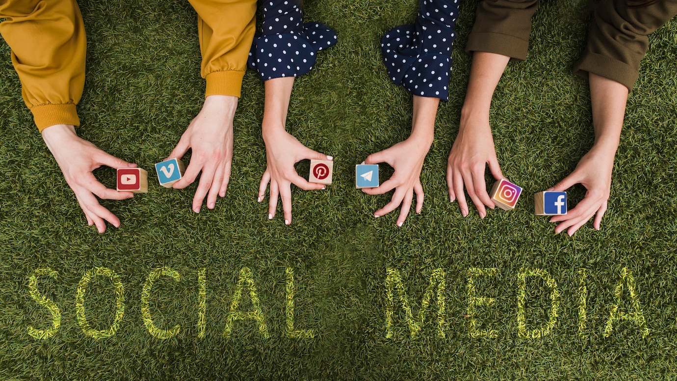 overhead-view-female-s-hand-holding-social-network-app-symbol-blocks-lawn-23-2147844474.jpg
