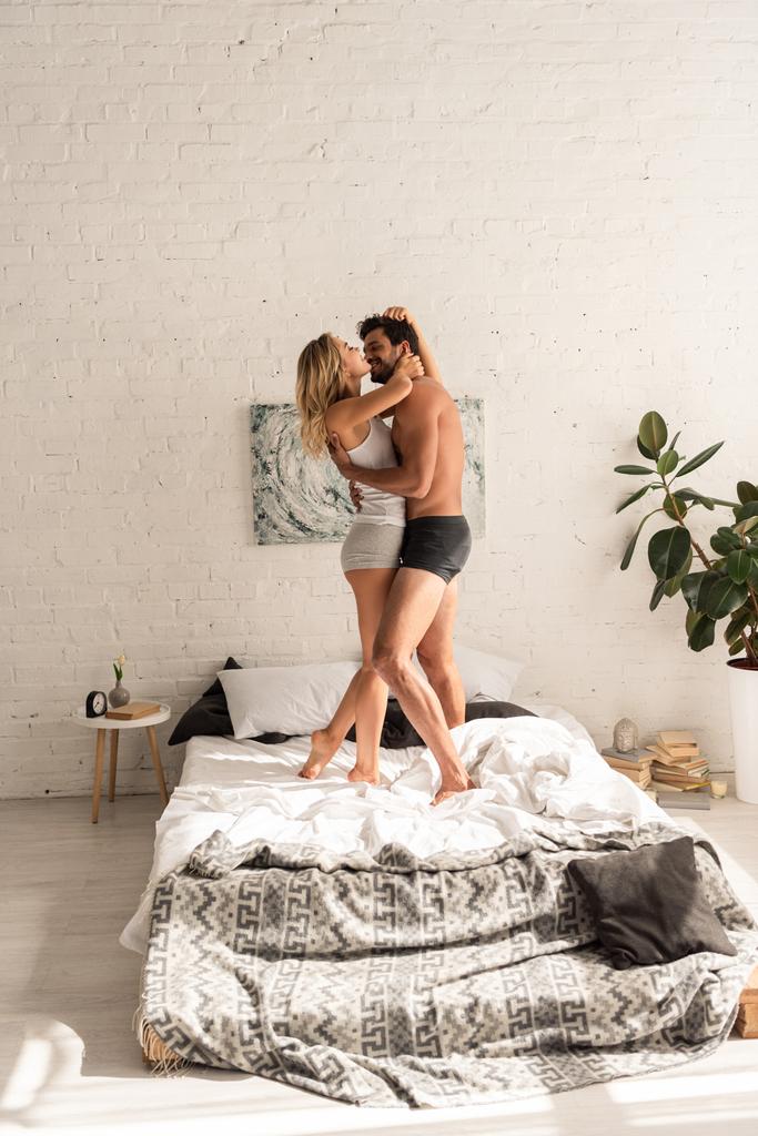 stock-photo-happy-couple-embracing-dancing-bed.jpg