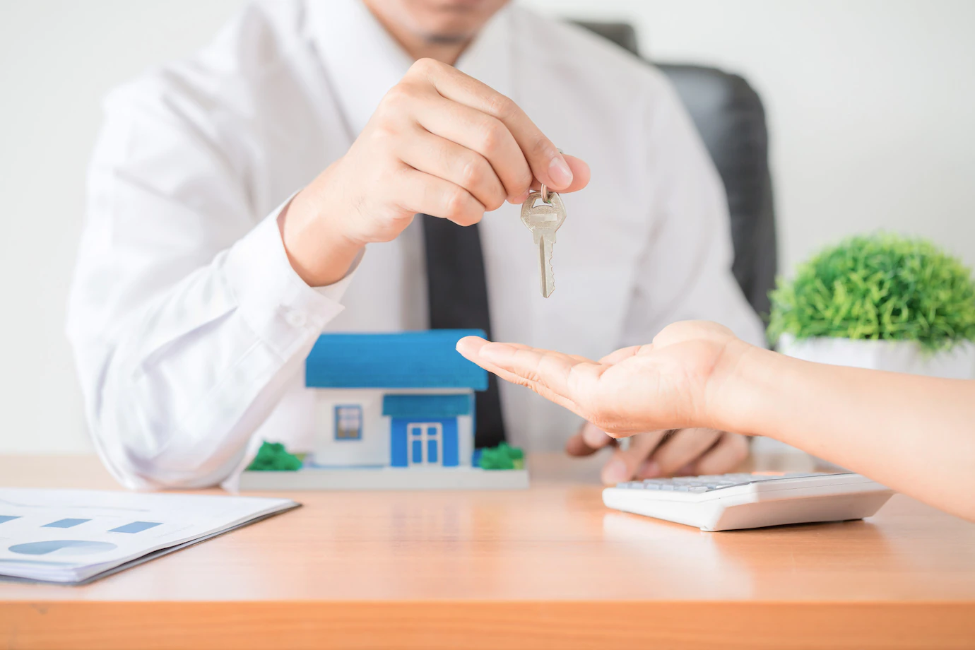 realtor-agent-giving-key-apartment-new-owner-1150-15013.webp