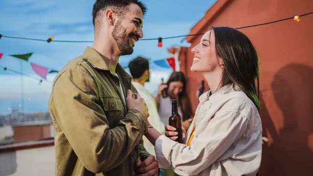 young-couple-flirting-outside.webp