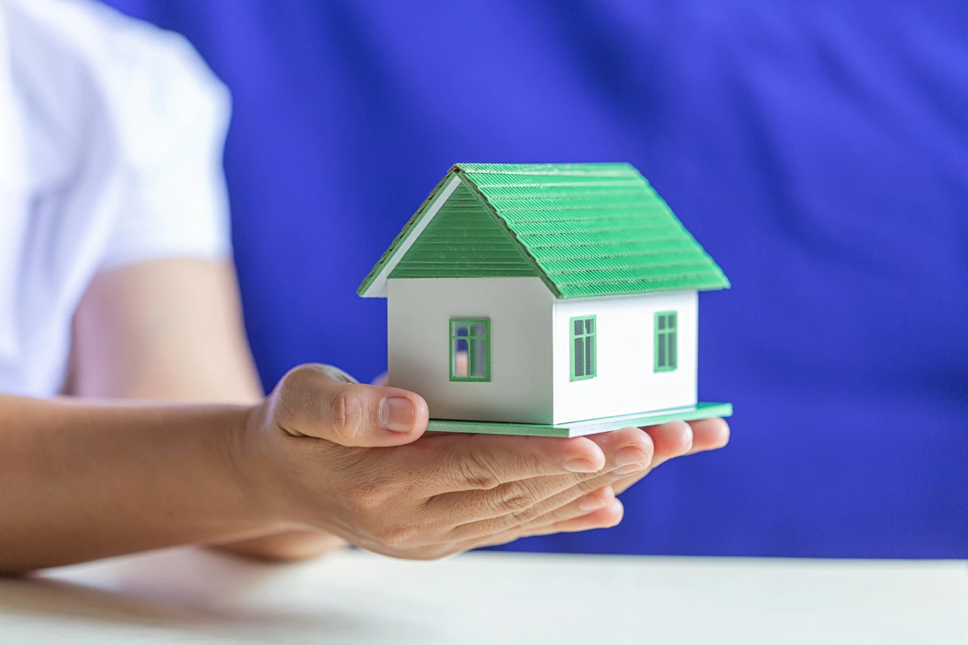 human-hands-holding-model-dream-house-1150-12790.webp