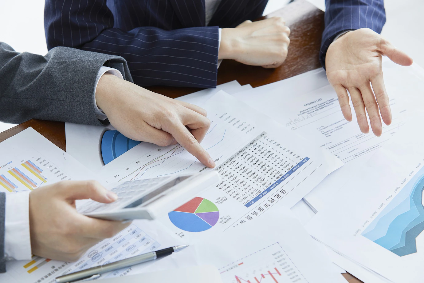businessmen-elegant-suits-business-meeting-making-calculations-office-181624-38939.webp