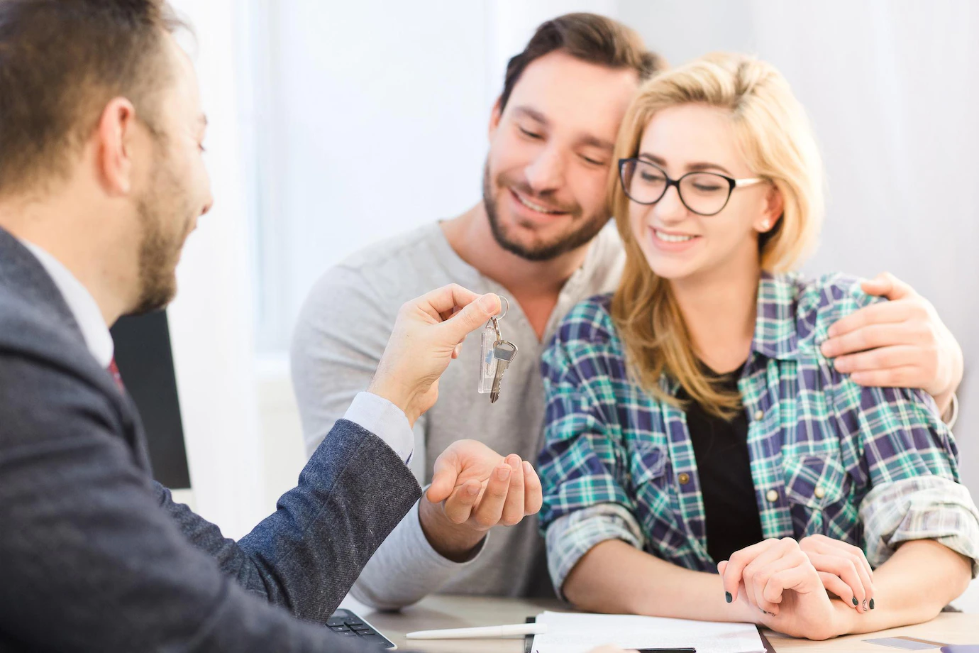 dealership-concept-bank-concept-toned-sales-manager-ready-give-key-young-couple-love-after-signing-agreement-contract-purchase-sale-549566-193.webp