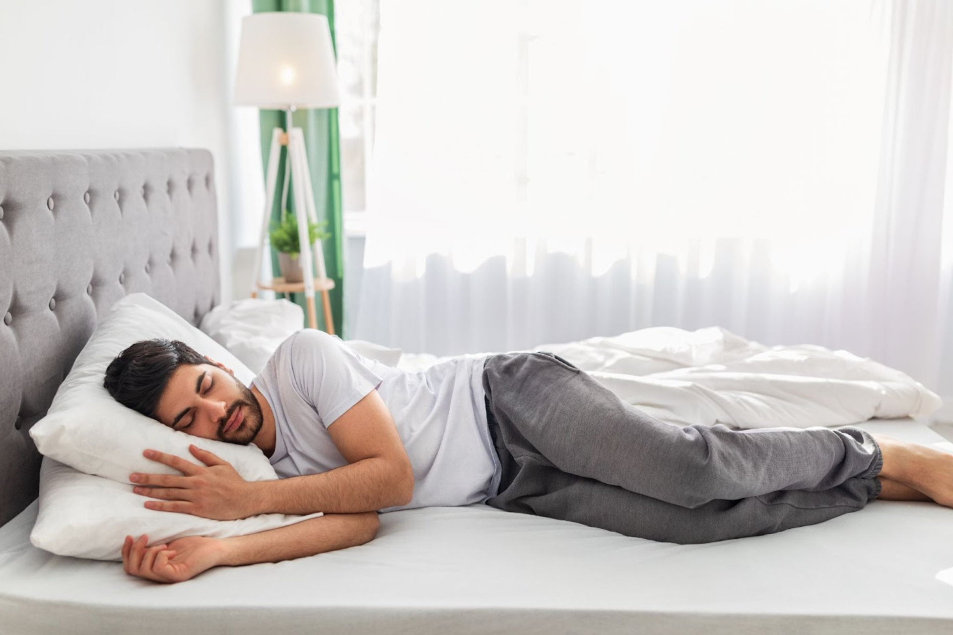 a-man-sleeping-peacefully-on-his-side-in-bed.webp