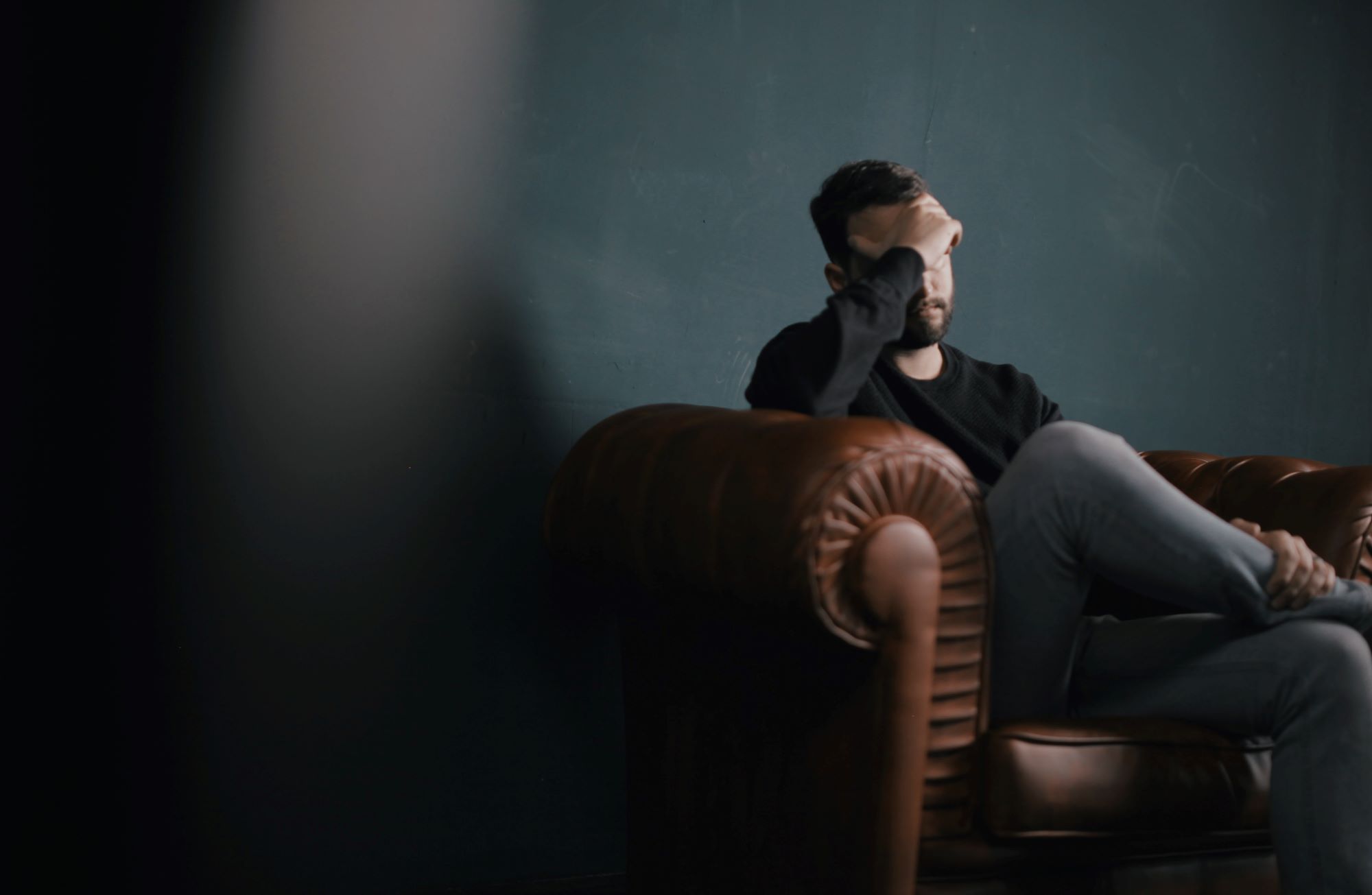 man-looking-sad-on-couch.jpg