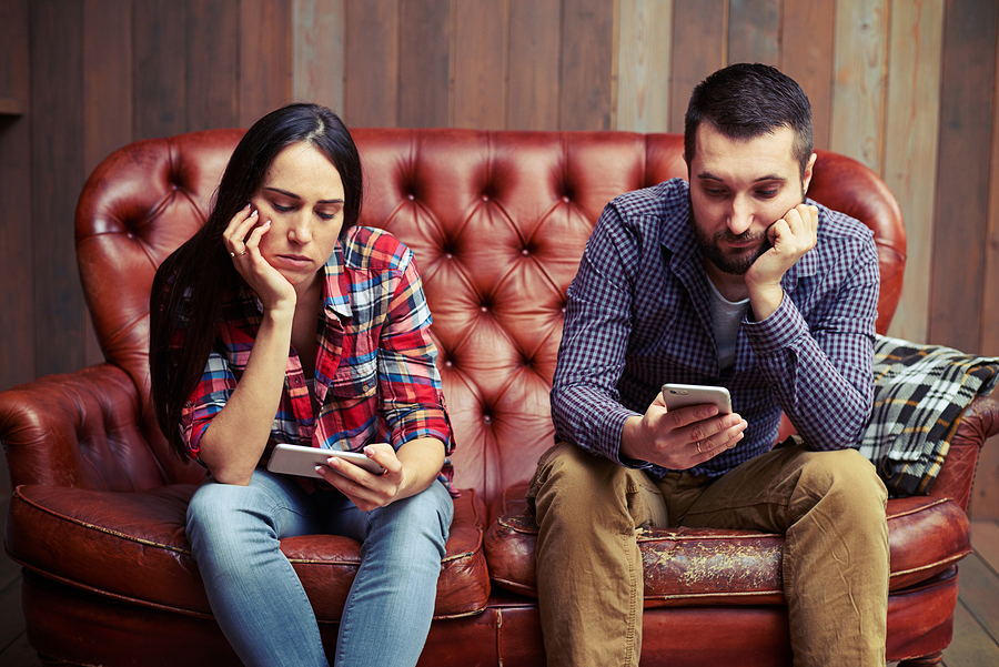 bigstock-bored-young-couple-sitting-on-119944202.jpg