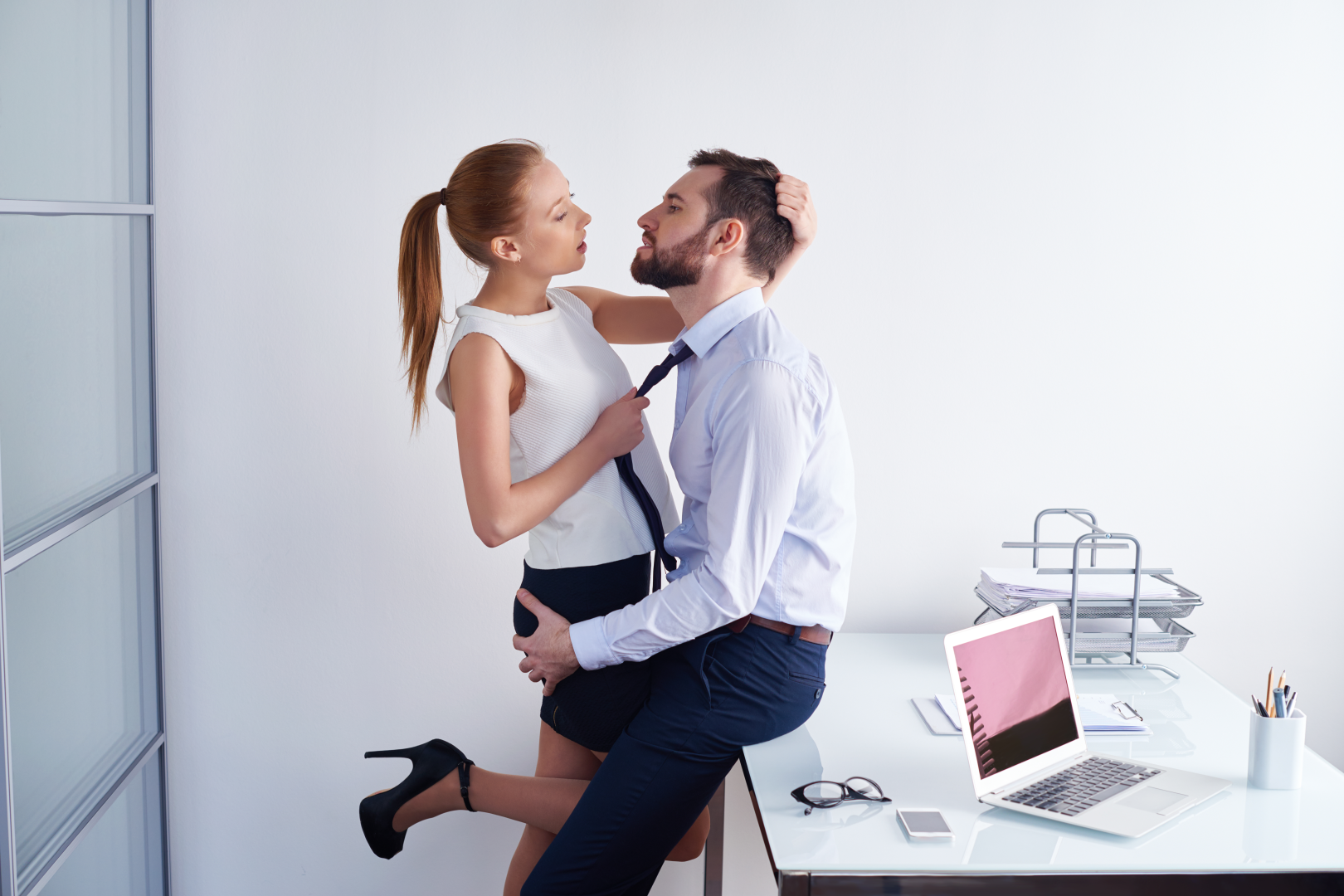 passionate-couple-sex-office-858120104.webp