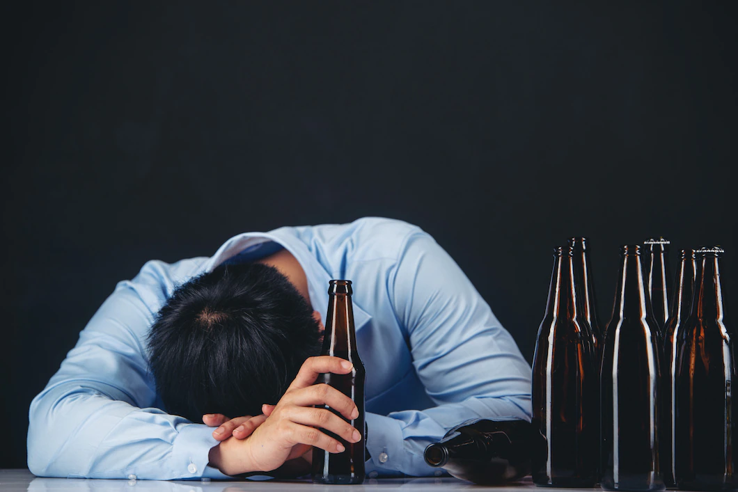 alcoholic-asian-man-with-lot-beer-bottles-1150-18661.webp