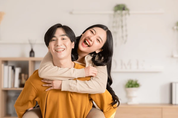 asian-young-couple-hugging-positive-600nw-2258003911.webp
