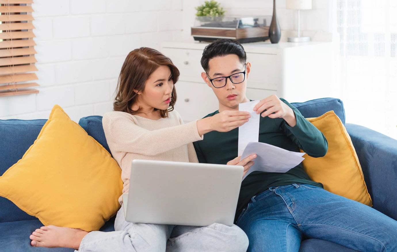 serious-asian-husband-checking-analyzing-statement-utilities-bills-sitting-together-home-74952-1247.webp